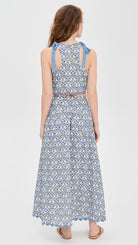 Woman wearing a patterned dress on a white background