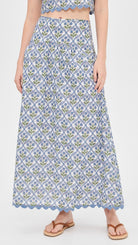 Woman wearing a blue patterned skirt on a white background
