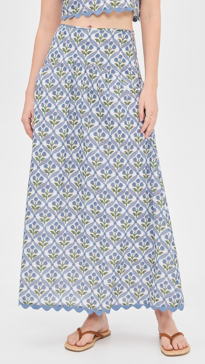 Woman wearing a blue patterned skirt on a white background