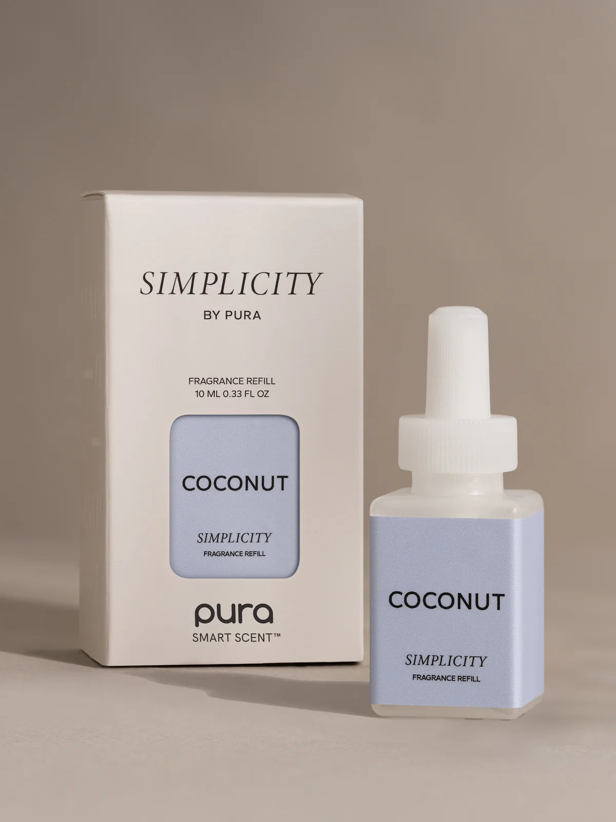 Pura Coconut Simplicity fragrance refill bottle and packaging on a beige background