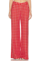 Red checkered pants worn by a person on a white background