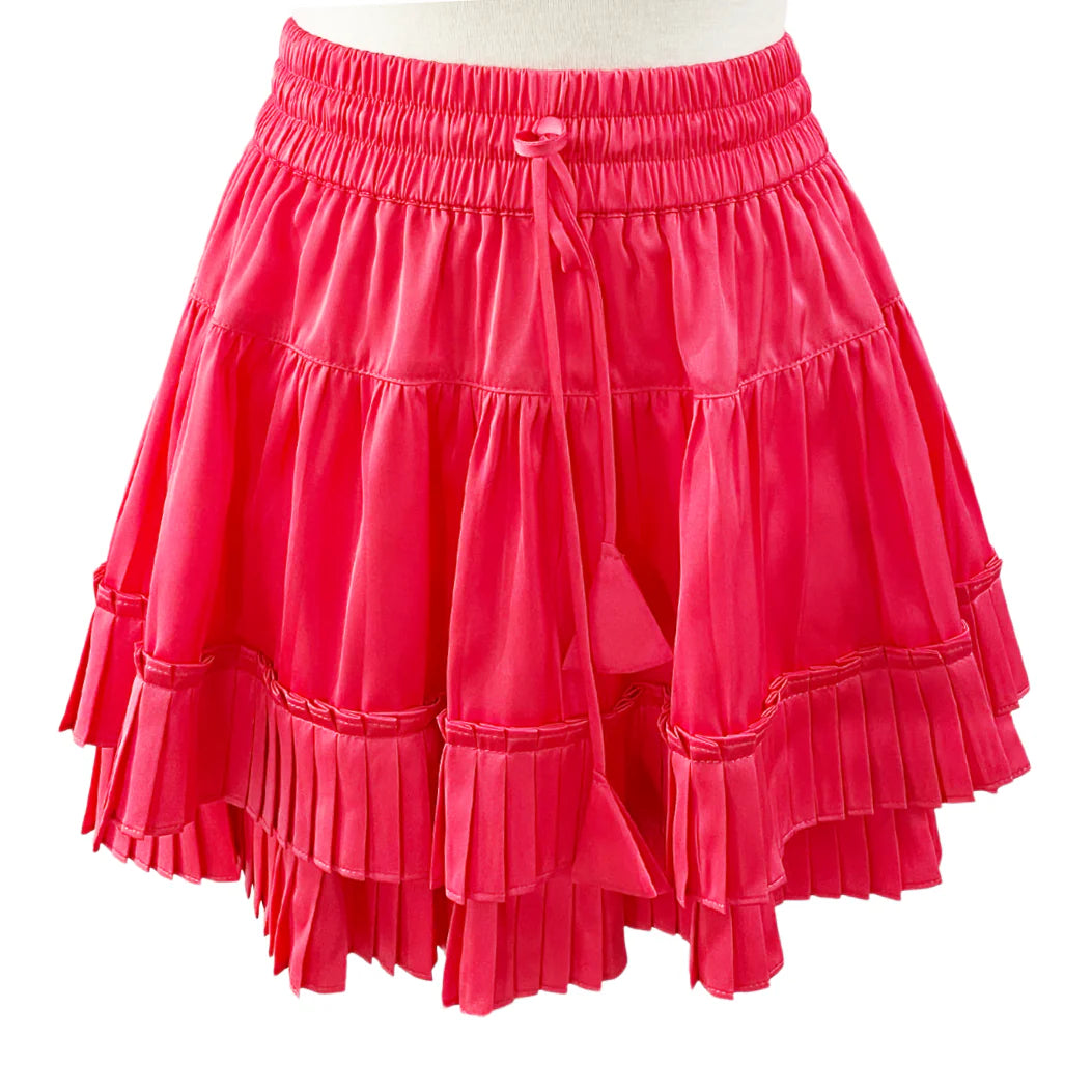 Red ruffled skirt on a mannequin against a white background